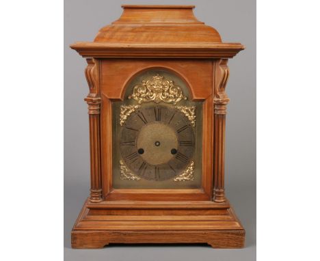 A mahogany 8 day mantel clock. With gilt dial and mask decoration.  