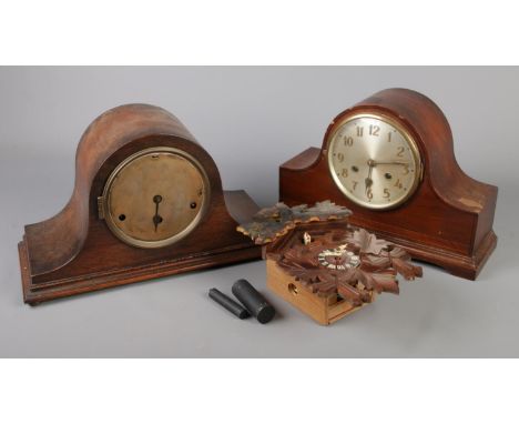Two wooden cased mantel clocks along with a vintage cuckoo clock.  