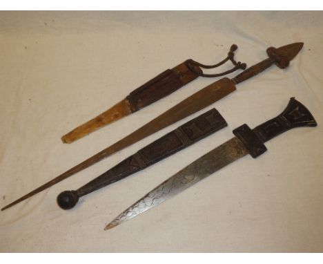 An African dagger with double-edged blade and leather mounted hilt in leather scabbard and one other African dagger (2)