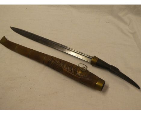 An unusual Eastern sword with 18" single-edged blade, horn bird's beak hilt in carved wood and brass mounted scabbard