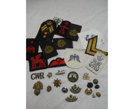 A selection of various military badges including a pair of Cornwall Light Infantry collar badges, South Wales Border's cap ba