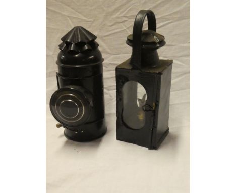 An unusual painted metal boat signal hand lantern with circular lens and one other painted metal hand lantern with loop handl