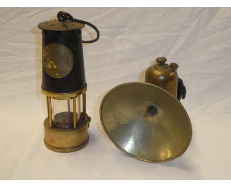 An old brass and steel bonnetted miner's lamp by the Protector Lamp &amp; Lighting Co.