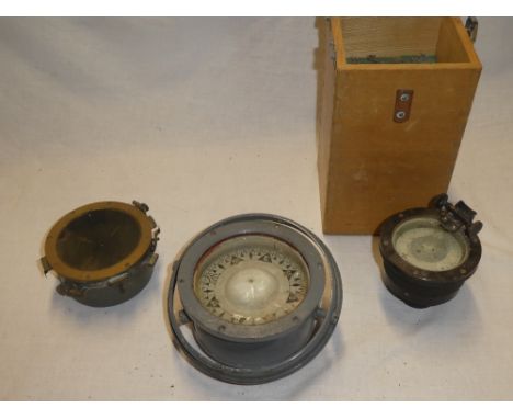 An Air Minstry-style brass mounted liquid compass and two other various small compasses