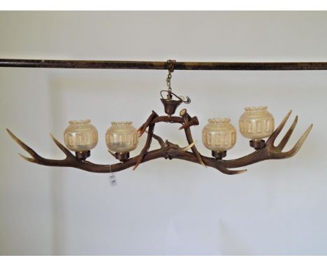 An Austro-German Red Deer Antler Ceiling Light Fitting, constructed from two Red Deer antlers with antler supports for the li