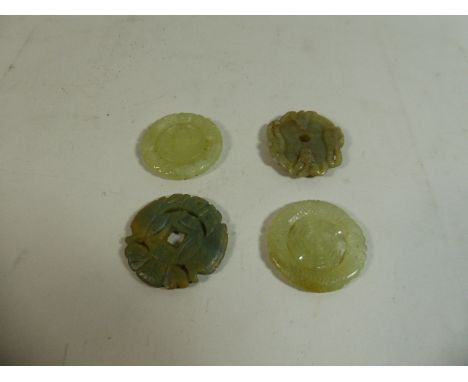 A Collection of Four Oriental Green Jade Disks with Carved Decoration 