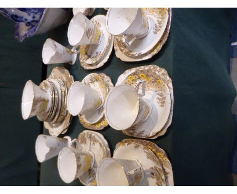 A Collection of Standard China, Daisy Field Pattern, Art Deco Teawares Comprising Six Trios, Sugar Bowl, Two Cream Jugs, Vari