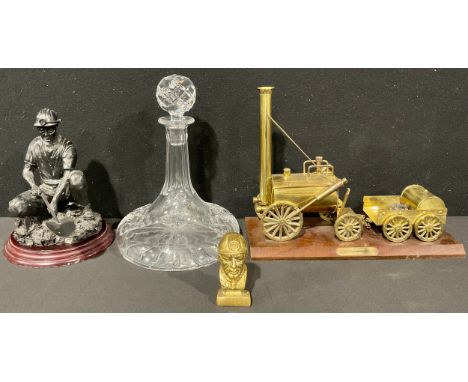 Mining Interest - a brass model, of Stephenson's Rocket, with cart, 26cm high, mahogany base, 33cm long; a gilt bronze cabine