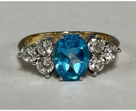 9ct gold Blue Topaz and Cubic Zirconia ring, the ring is set with an oval brilliant cut blue topaz in the centre that measure