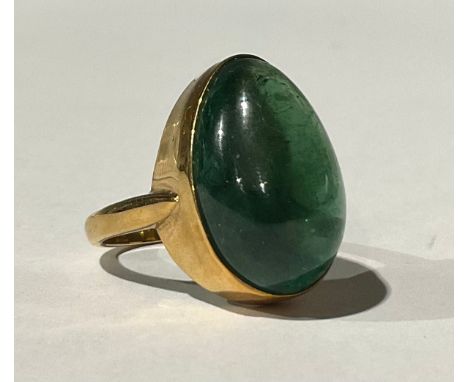 A 9ct Gold Green Tourmaline? Ring The ring is set with an egg shaped cabochon Green Tourmaline? that measures approx. 19.90mm