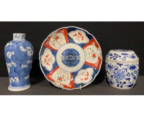 A Chinese baluster vase, painted in tones of underglaze blue with blossoming prunus on a ground of cracked ice, 18.5cm high, 