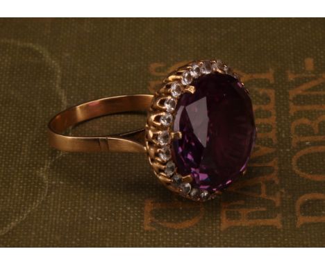 An 18ct gold synthetic purplish-pink sapphire and cubic zirconia dress ring, the centre sapphire measures approx 17mm x 17mm 