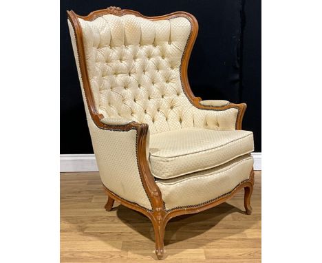 A Louis XV Revival salon chair, stuffed-over upholstery, button back, squab cushion, 107.5cm high, 78cm wide, the seat 50cm d