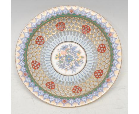 A mid 19th century Chamberlains Worcester reticulated saucer dish, the field decorated with stylised flowers and foliage, the