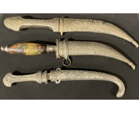 A Middle Eastern jambiya dagger, with inlaid horn handle, 27cm; another, with decorated dual edged blades and Arabic inscribe