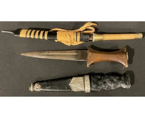 A Scottish sgian dubh knife, Sheffield make, 18cm long; another, an early wooden handled dagger, double edged, fullered blade
