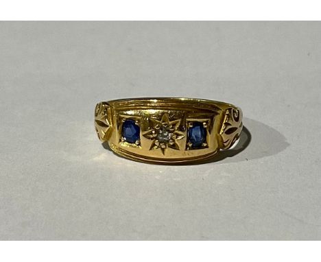 An Antique Sapphire and Old Mine Cut Diamond Trilogy Ring;the ring is set with a melee old mine cut diamond in the centre wit