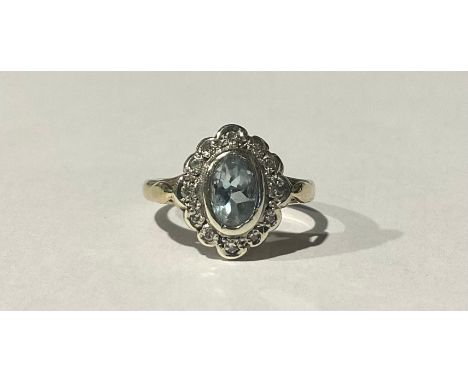 A 9ct Gold Aquamarine and Diamond Ring;set with an oval brilliant cut pale blue aquamarine that measures approx. 0.50ct (1/2 