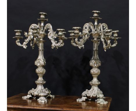 A pair of substantial Rococo Revival cast metal six-light, five-branch candelabra, cast throughout with scrolling acanthus, 6