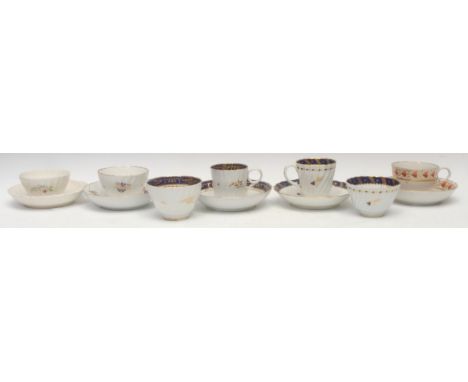 A Flight Worcester spirally fluted trio, with blue and gilt border, early 19th century; a similar Chamberlain trio; a spirall