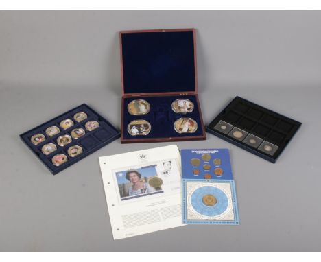 A collection of Westminster Collection and Windsor Mint coins and cases as well as other commemorative coins including the Qu