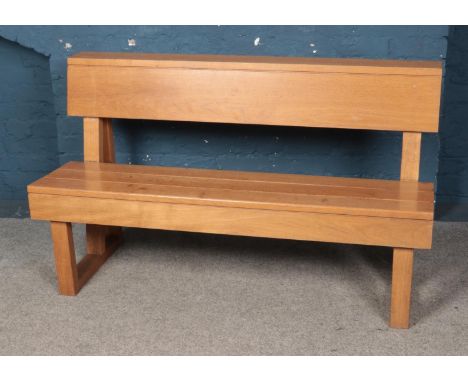 An oak paneled bench. Approx. dimensions 141cm x 83cm x 51cm.  