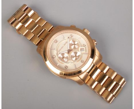 A Michael Kors gold tone chronograph wristwatch, with stainless steel bracelet.  