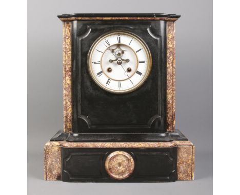 A black slate and marble mantel clock, with O. Berger movement on white enamel dial and Roman Numeral markers. Height: 39cm. 