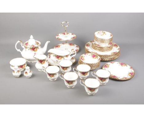 A Royal Albert Old Country Roses tea set including cake stand, tea pot, serving plates and more.  One dinner plate chipped to