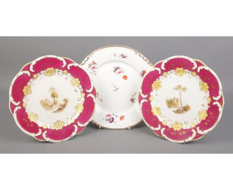 Three Rockingham porcelain plates. Includes two dessert plates with C-scroll moulded borders and central hand painted landsca
