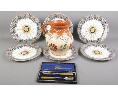 Six Wedgwood Etruria cabinet plates along with a pottery jug and a cased silver plated cutlery set.  