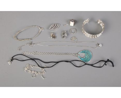 A quantity of silver jewellery including bangle, cat brooch, earrings and pendants. Weighable silver 57g.  