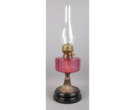 A Flash of Slough flamingo glass and brass oil lamp, on stepped circular base.  