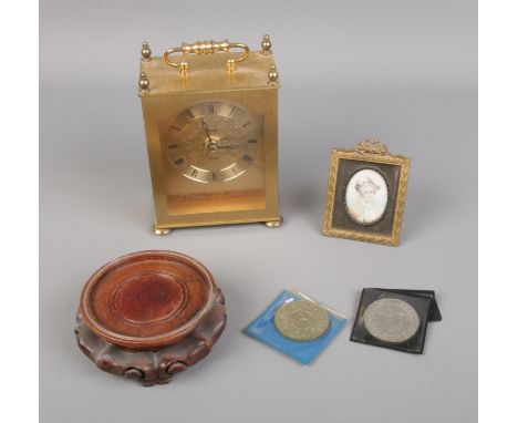 A small quantity of collectables including painted miniature on porcelain, quartz carriage clock, commemorative crowns, etc. 