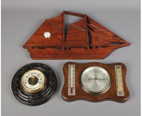 A Winter &amp; Sons aneroid wall barometer along with similar barometer and wall clock formed as a ship.  