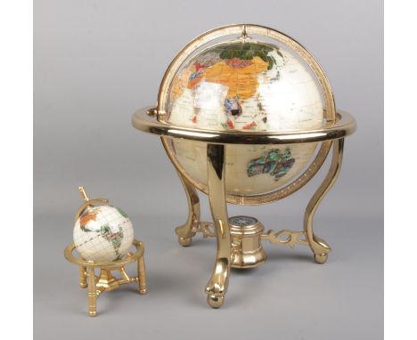 Two modern gemstone globes on stands; with the largest having a compass in the base of the stand. Height of largest: 35cm.  C