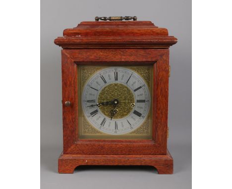 A mahogany cased mantle clock with top bracket and Arabic numeral dial. Movement stamped for FHS, Germany, 340-020. Key prese