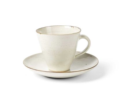 § Dame Lucie Rie (British 1902-1995) Cup and Saucer, circa 1950 impressed artist's seal, stoneware, white glaze with manganes
