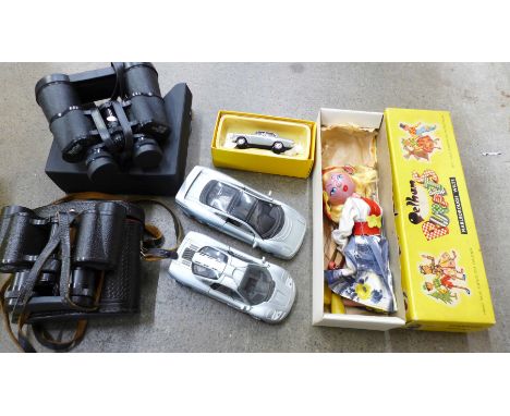 A pair of Vivitar 16x50 binoculars, a pair of USSR 8x30 binoculars, both cased, a Pelham Puppet Tyrolean Girl, a Vanguards Au