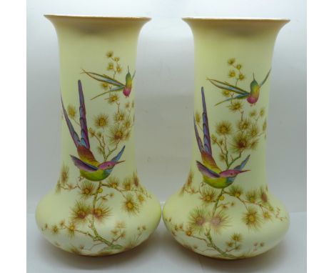 A pair of Crown Ducal Edwardian blush ivory vases, decorated with birds and butterflies, one a/f (hairline), 23cm 