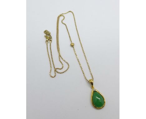 A silver gilt, jade and diamond pendant and chain 