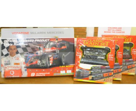 A Micro Scalextric set, Lewis Hamilton McLaren Mercedes, 1:64 scale and three battery operated Classic Train Sets, boxed 