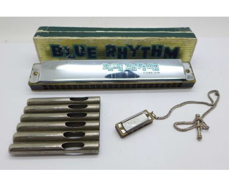 A Blue Rhythm harmonica, a miniature harmonica and a set of pipes 