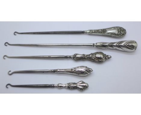 Five vintage silver handled button hooks 