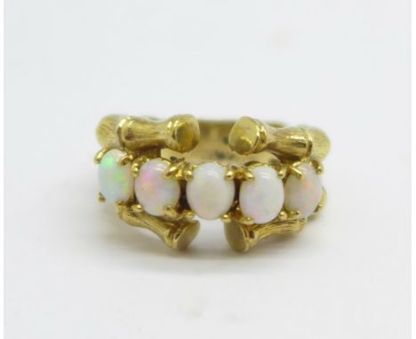 A 9ct gold, five stone opal ring, 7g, M, one stone a/f 