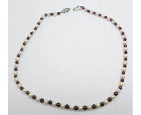 A pearl and garnet necklace with silver clasp 