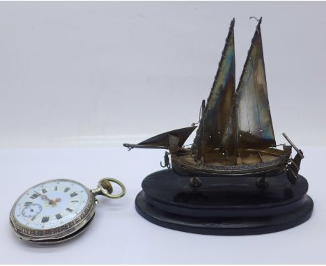 A white metal model sailing boat on stand, with continental marks, and an 800 silver pocket watch with enamel dial and case b