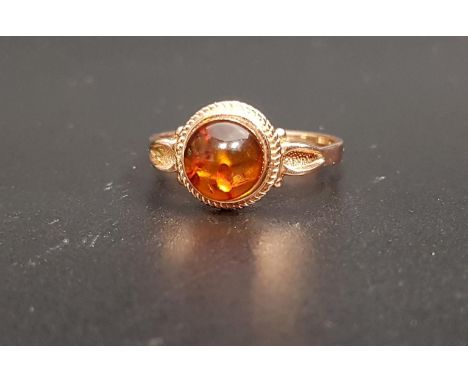 RUSSIAN AMBER SET RINGthe central round cabochon amber on fourteen carat rose gold shank with decorative shaped shoulders, ri