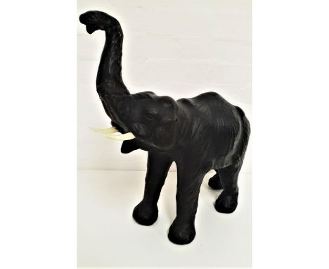 DECORATIVE LEATHER ELEPHANTwith his trunk raised and mouth open, with decorative tusks, now lacking ears, 55cm high 