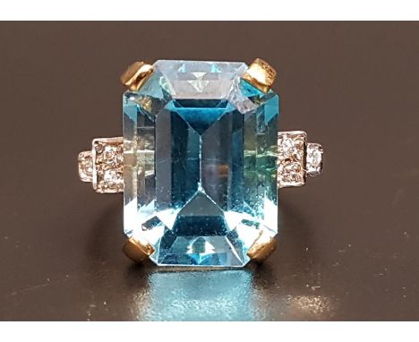 BLUE TOPAZ AND DIAMOND COCKTAIL RINGthe large emerald cut blue topaz measuring approximately 15.4mm 11.6mm x 8.4mm, flanked b